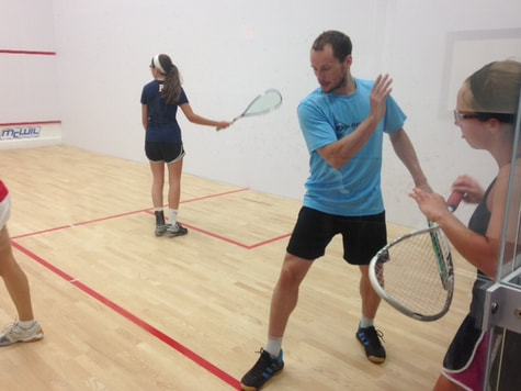 Greg Gaultier instructs junior squash players how to swing their squash rackets
